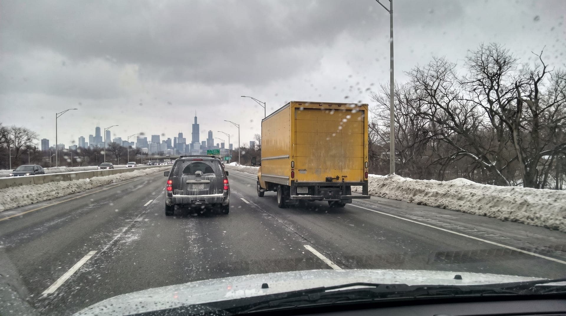 A moving truck leaving Chicago on a winter expressway